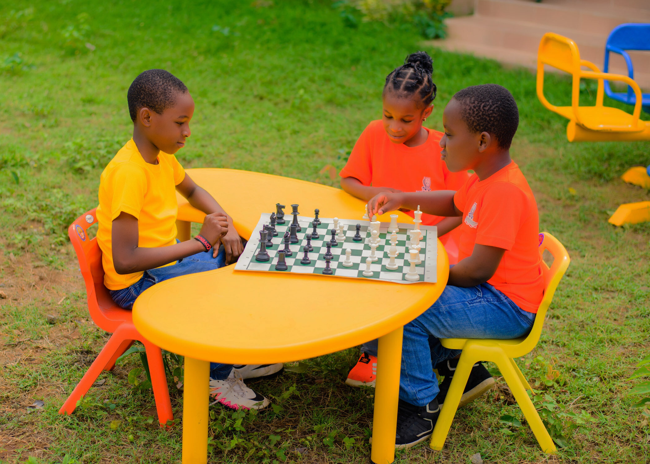 Noble Brains Academy pupils playing chess outdoors